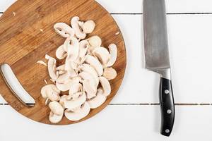 Chopped Mushrooms on the round wooden cutting board (Flip 2020)