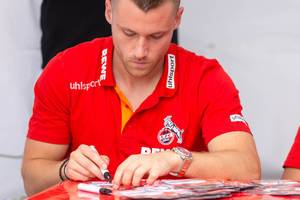 Christian Clemens signing autograph cards for fans