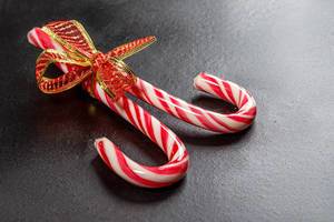 Christmas candy canes on a black background (Flip 2019)