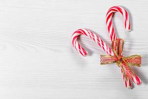Christmas candy canes on a white wooden background (Flip 2019)