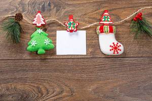 Christmas decor with thread on brown wooden background with free space