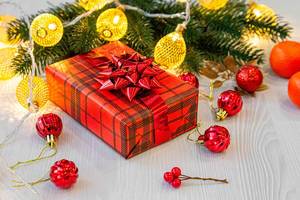 Christmas gift in red packaging with ribbon, garlands and balls (Flip 2019)