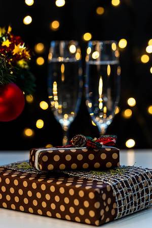 Christmas presents and glasses of champagne on bokeh background (Flip 2019)