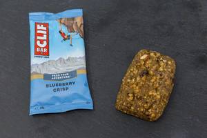 Clif Bar - Energy Bar with Blueberry Crisp Flavor and Packaging on black plate