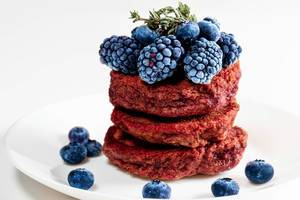 Close-up, beetroot pancakes with blueberries and mulberries