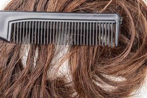 Close- up, black comb on dark female hair (Flip 2020)