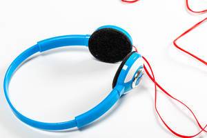 Close up blue headphones with red cords
