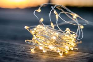 Close Up Bokeh Photo of Decorative Wire Light with Sunset in Background