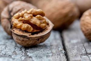 Close Up Bokeh Photo of Opened Walnut on Wooden Table
