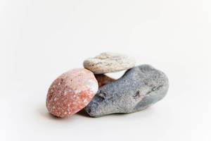 Close Up Bokeh Photo of Stack of Stones on White Background
