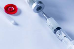 Close Up Bokeh Photo of Syringe, Ampoule on white Table