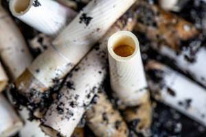 Close-up, cigarette butts with ash
