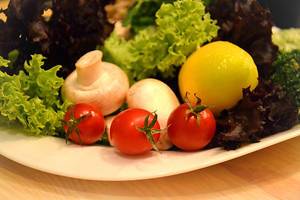 Close Up Food Photo of Fresh Vegetables including Cherry Tomatoes, Mushrooms and Lettuce