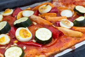 Close Up Food Photo of Homemade Vegetarian Pizza with Zucchini, Bell Pepper, Tomatoes and Egg