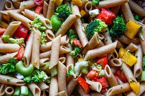 Close Up Food Photo of Penne Pasta with Tomatoes, Bell Pepper and Broccoli
