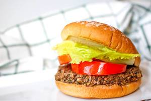 Close Up Food Photo of Vegan Burger with Black Bean Patty, Tomatoes and Lettuce