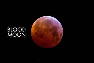 Close up of a red full moon with black background and picture title: Blood moon