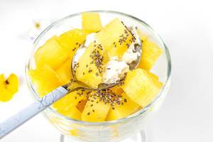 Close- up of a spoon with cottage cheese, pineapple slices and Chia seeds (Flip 2020)