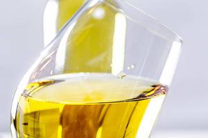 Close-up of a tilted glass of white wine