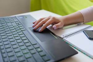 Close Up of a womans hand using the touchpad of a laptop