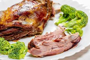 Close-up of baked lamb with broccoli on a plate