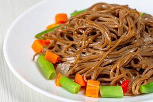 Close-up of buckwheat soba noodles with asparagus, carrots and sweet peppers (Flip 2019)