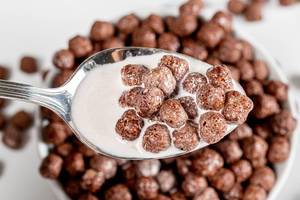 Close up of chocolate corn balls with milk