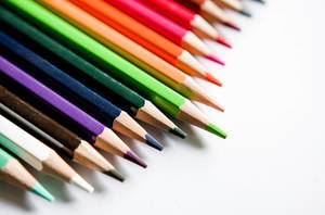 Close Up of Color Pencils in different Colors on White Background