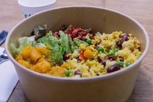 Close up of colourful lunch: Vegan Organic Vital Bowl with salad, kidney beans, rice, peas and teriyaki tofu