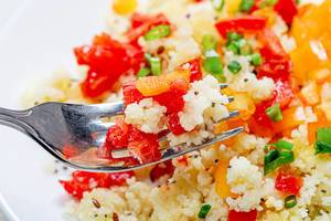 Close up of cooked porridge couscous with vegetables on a fork (Flip 2019)