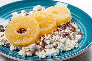 Close up of cottage cheese with flax seeds and dried pineapple rings (Flip 2019)