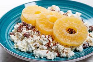 Close up of cottage cheese with flax seeds and dried pineapple rings