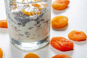 Close up of cottage cheese with yogurt and Chia seeds in a glass with dried apricots (Flip 2019)