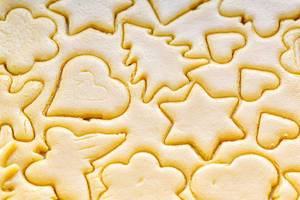 Close-up of cut different shapes of cookies in raw dough