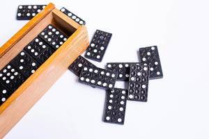 Close up of domino set with wooden box on white background