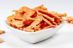Close- up of dried pumpkin slices in a white bowl (Flip 2020)