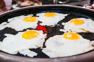 Close up of fresh eggs being fried