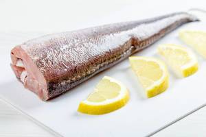 Close-up of fresh heck fish with lemon slices (Flip 2019)
