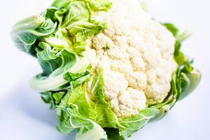Close up of fresh whole cauliflower on white background