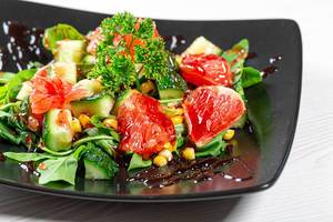Close-up of fruit and vegetable salad with pomegranate sauce