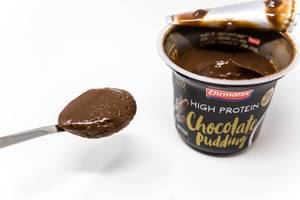 Close Up of german High Protein Chocolate Pudding on a spoon, made of dark Chocolate by Ehrmann