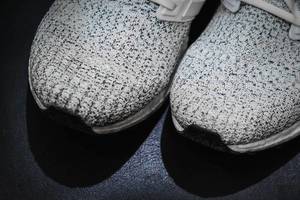 Close up of knitted sneakers on black surface