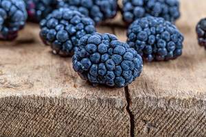 Close-up of mulberry berries on a wooden background