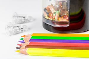 Close-up of multi-colored pencils with an electronic sharpener (Flip 2020)