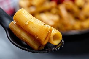 Close-up of pasta in black spoon