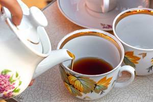 Close-up of pouring tea from a teapot into a Cup (Flip 2019)