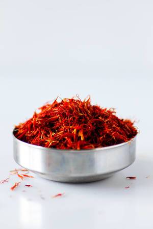 Close-up of saffron threads in a metal bowl
