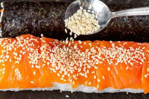 Close-up of sesame pours on sushi roll with salmon (Flip 2019)