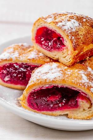 Close-up of sliced cherry roll with powdered sugar