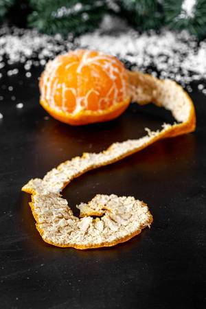 Close up of tangerine with peeled peel on dark background (Flip 2019)